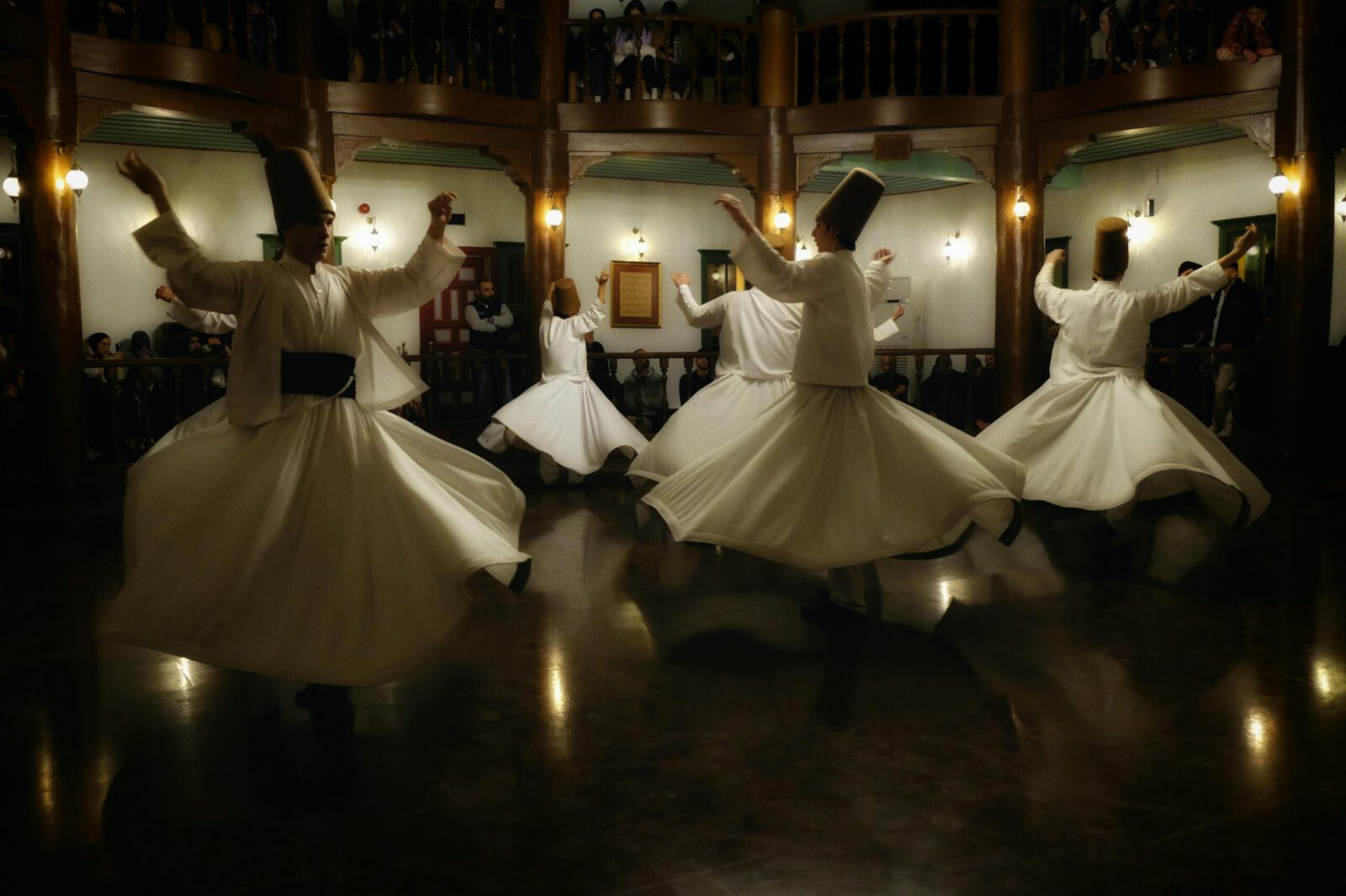 Whirling dervishes in traditional attire perform the sacred Mevlevi Sema ceremony in Bursa, Türkiye.