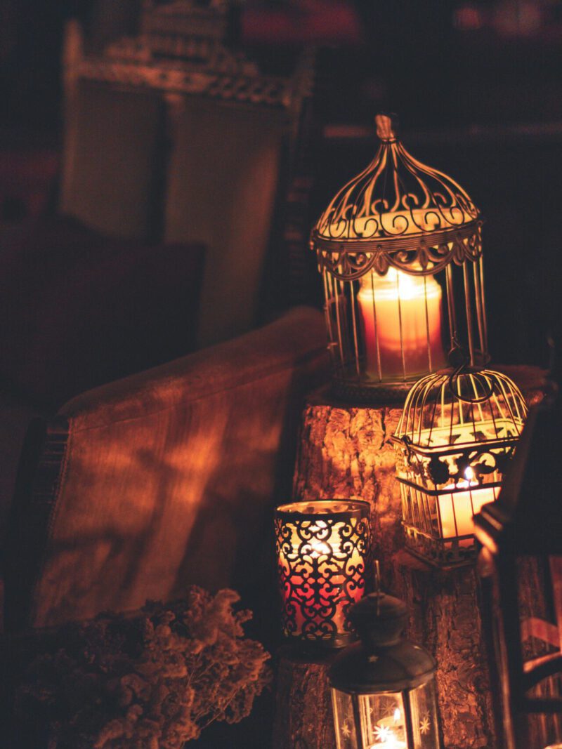 A cozy indoor scene with glowing lanterns and candles, perfect for creating ambiance.